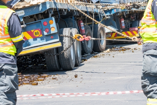 two officers standing behind a jackknife accident