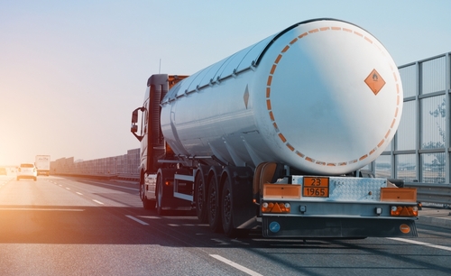 Tanker truck on road with sun flare